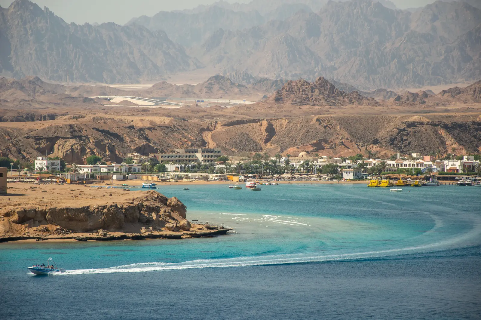 A Sharm El Sheikh bay with hotels along the shore and the Sinai mountains behind