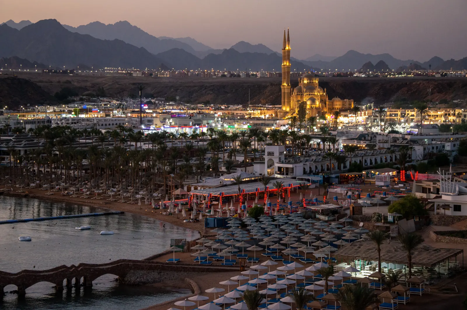 Sharm El Sheikh at dusk, with a lit mosque and the beach