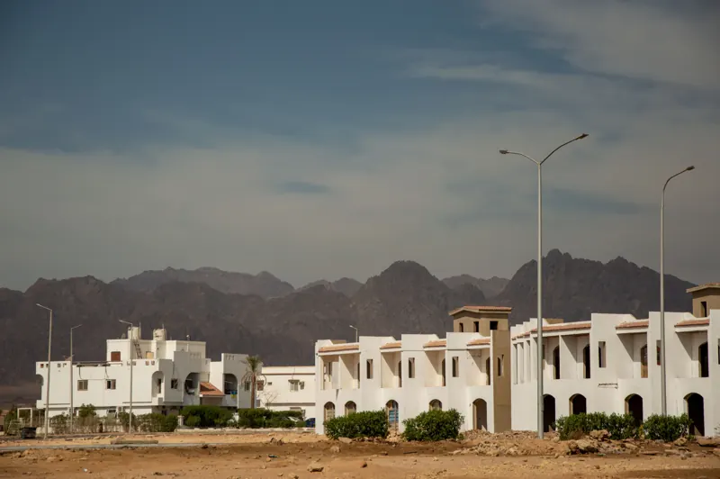 White homes below desert mountains